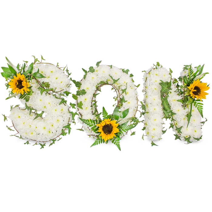 A sculpted funeral display that clearly spells SON, crafted from hundreds of small, pure white chrysanthemums packed tightly to form solid, soft-lettered capitals against a pristine white studio background. Winding through the dense chrysanthemum base are glossy strands of dark green ivy with their characteristic lobed leaves, interspersed with lighter green fern fronds and assorted leafy sprigs which provide depth, shadow, and a naturalistic frame to each letter. Three large sunflowers-vivid yellow petals radiating from textured, dark brown centres-serve as focal anchors: the first is placed on the upper-left curve of the S, the second is set low inside the O's circle, and the third accents the upper-right of the N. The arrangement's composition balances the serenity of white mourning flowers with the hopeful brightness of sunflower faces, creating a visual narrative of remembrance and affection. Photographed with crisp, even lighting that reveals petal detail and leaf veining, the piece reads both in close-up editorial shots and from a distance at a chapel or funeral parlour. As a working florist in St Mary Cray with frequent deliveries to nearby chapels and cemeteries around St Paul's Cray and Orpington, I assemble tributes like this to convey respect and personalised memory-each stem chosen for condition, colour fidelity, and the quiet comfort it brings to mourners.